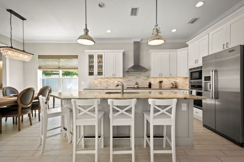 The large kitchen island can seat 4 comfortably. A booster seat can be added.