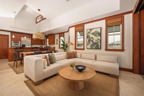 Step into your bright, open-concept retreat with soaring ceilings, rich wood accents, and natural light pouring in. Sink into the plush sectional or gather in the adjoining kitchen—your perfect home base for unwinding after island adventures.
