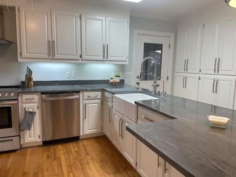 Glass top range, oven, microwave, dishwasher, pots, pans, and full dish set