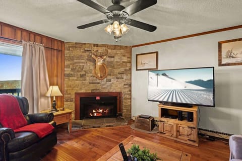 Living room bliss: Comfy couch, recliner, fireplace warmth, and a smart TV for movie magic.