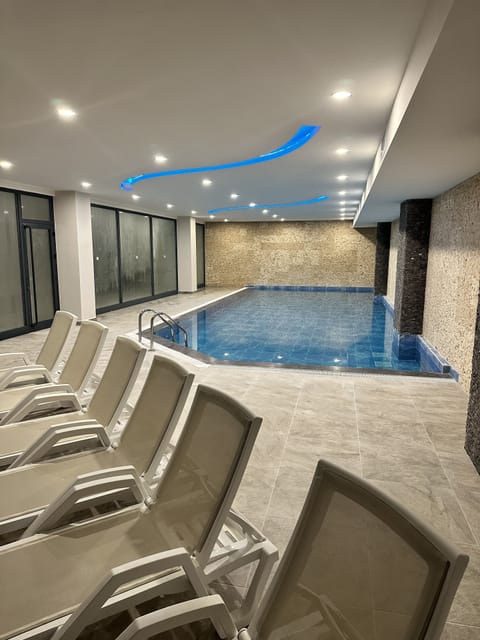 Indoor pool, seasonal outdoor pool, pool umbrellas, lifeguards on site