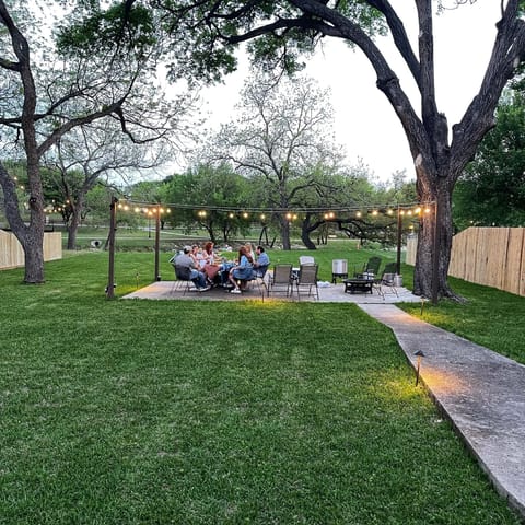 Backyard with lit seating area.