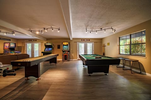 Game room with lots of games and 75 inch smart TV to catch the game or show. 