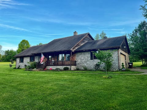 Front view of stone and cedar ranch with plenty of private parking