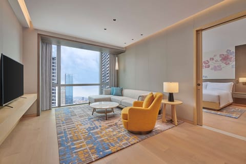 Junior Suite, 1 King Bed | Living area | 55-inch LED TV with cable channels, TV