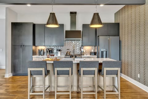 Modern sleek kitchen stocked with your basic cooking essentials. Complete with stainless steel appliances and breakfast bar seating.