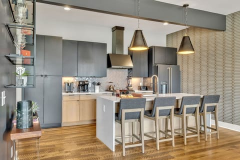 Modern sleek kitchen stocked with your basic cooking essentials. Complete with stainless steel appliances and breakfast bar seating.