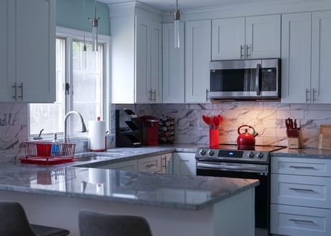 Enjoy preparing your meals in this modern kitchen featuring elegant marble.