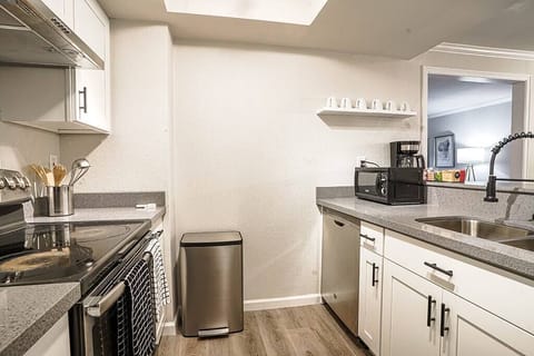 Full kitchen with dishwasher, oven, hood and microwave