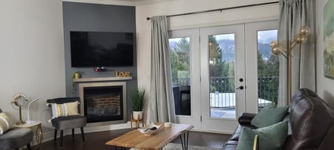 Comfort Condo | Living area | 50-inch TV with cable channels, DVD player
