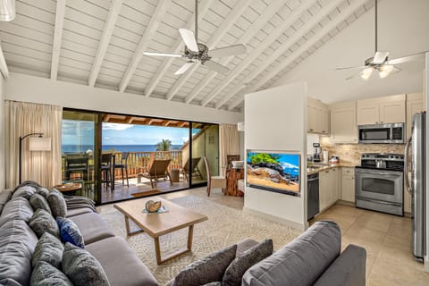 Your open-concept retreat blends island comfort with ocean views, where vaulted ceilings, plush seating, and a fully equipped kitchen create the perfect space to unwind after beach days.