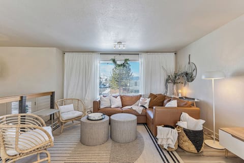 Comfortable living room seating with plenty of pillows and throw blankets.