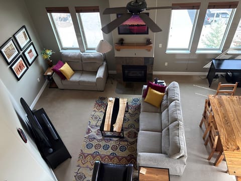 View from loft of large, well-lit open great room & dining room