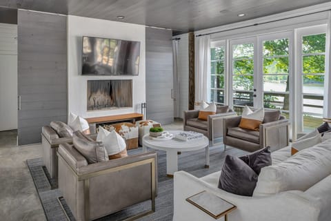 Spacious open concept on main level, completely adjacent to lake views. 