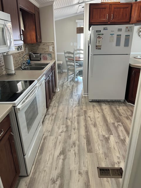 Fully stocked kitchen equipped with microwave and electric stove