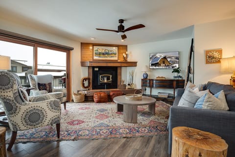 Curl up in your cozy living room where rustic charm meets modern comfort, complete with fireplace and mountain views.