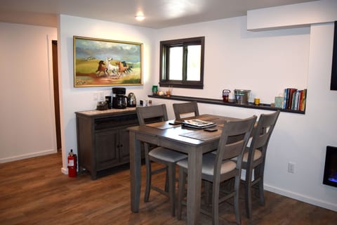 Coffee/tea bar with dining dishes and silverware.  My Mom painted the artwork!