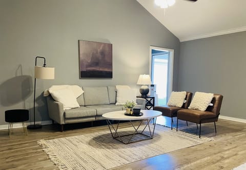 The living room with seating for 6 and a smart tv.