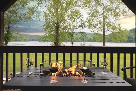 Serene Lake Views from the private 50-foot deck. Enjoy meals, soaking in the hot tub, and relaxing around the fire table on this covered deck every morning and night.