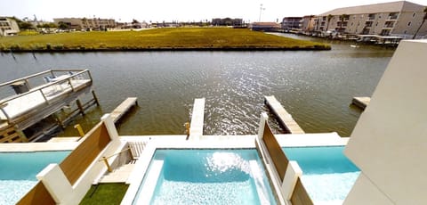 View of the pool, dock, & canal from the third-story deck.