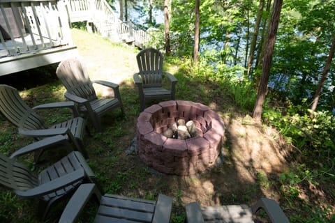 Fire pit next to the hot tub overlooking the water! Private 2.5 acres of woods!
