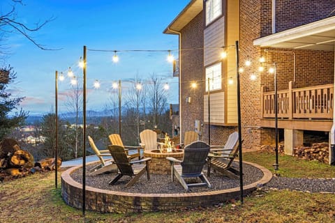 Lit up fireplace looks out on the long mountain views