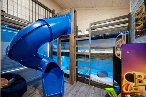 Kids love the bunk room, featuring a tube slide, secret path, play area above the bunks, and five twin bunk beds, plus a Street Fighter arcade.
