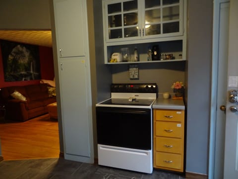 Kitchen with full stove and refrigerator