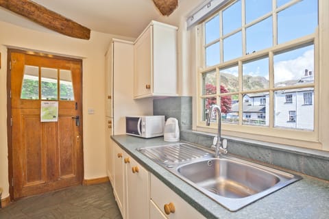Old Post Cottage Coniston  kitchen with view over beck