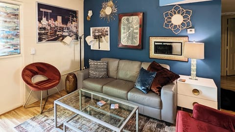 Spacious living room with smart phone across from sofa