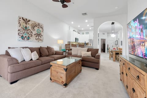Open space living room with kitchen in background