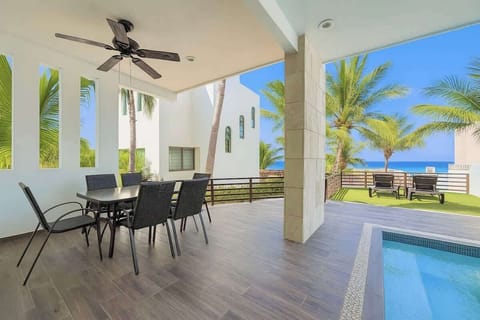 Bright open-plan living and dining area with modern furnishings and A/C