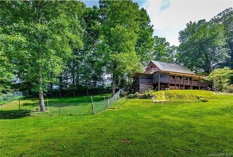 View of fenced yard and screen in porch