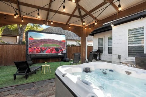 Private backyard oasis with hot tub & outdoor theater for movies or game day.