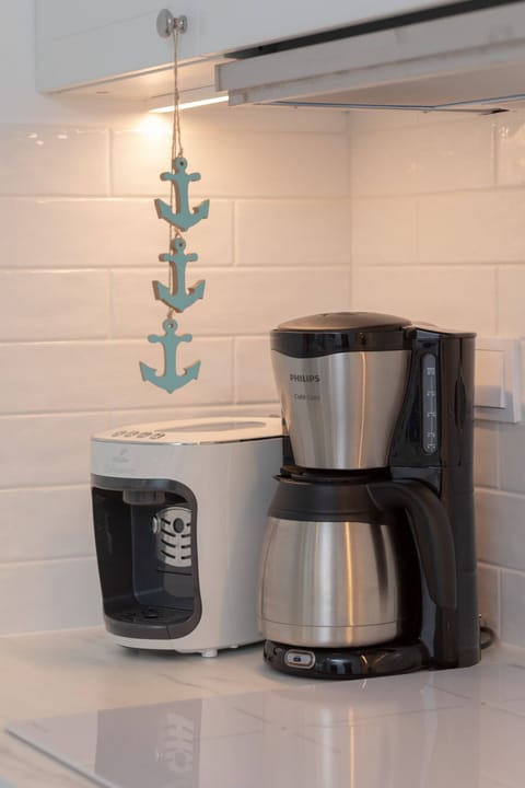 Two coffee machines (capsule and overflow) in the kitchenette.