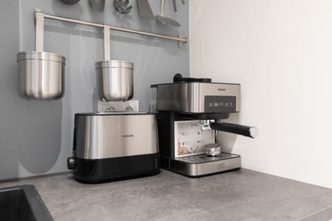 Kitchenette with toaster, electric kettle and coffee machine.