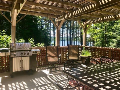 Second story deck with lake views, dining table for 8, sitting area and grill
