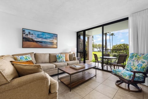 Relax in your bright living room with tropical touches and step out to your private patio overlooking lush lawns and swaying palms—your perfect island escape awaits.