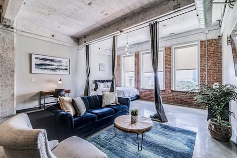 Urban elegance with exposed brick, plush seating, and stunning skyline views!