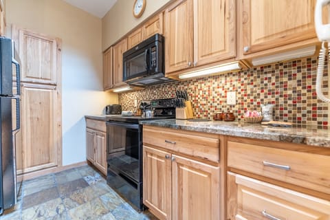 Full-sized kitchen with updated appliances and granite countertops.