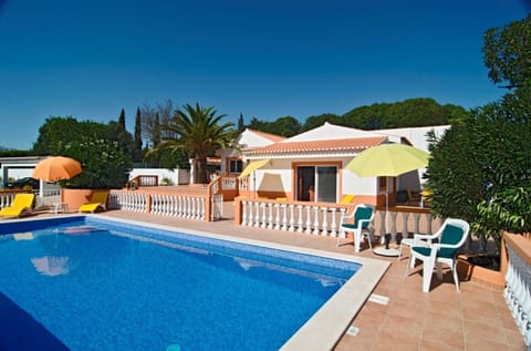 The private pool area of Villa Mariposa is fenced so that small children cannot access the pool unsupervised. Behind it, a large terrace extends to the house.