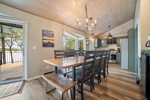 Open concept access to large deck with dining table and 1 gas grill,1 Traeger