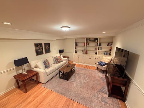 Cozy lounge area with 55" 4k TV and queen-sized pull-out couch.