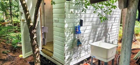 Shower Entrance with Outdoor utility sink for washing dishes.