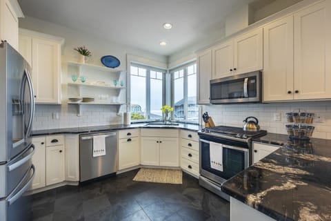 Kitchen with refrigerator, gas stove, dishwasher, and microwave