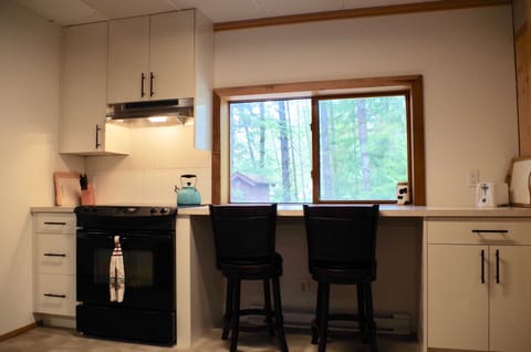 Kitchen showing stove/oven and one seating area.
