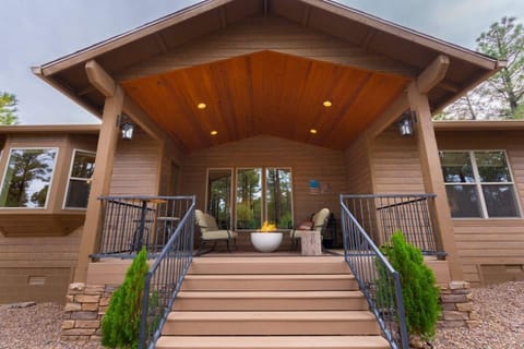 You'll feel your shoulders drop the moment you reach this porch, fire pit glowing and forest pulled in close on every side. The slower pace of the whole trip basically starts right here.