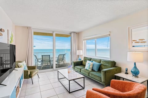 Unwind in your oceanfront living room where floor-to-ceiling windows frame endless sea views and your private balcony awaits.