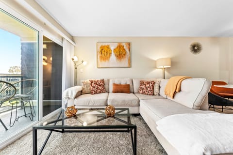 Sunlit living space with plush sectional sofa for ultimate relaxation.