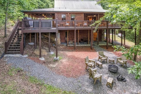 Rear view of fire pit, hot tub, and outdoor seating